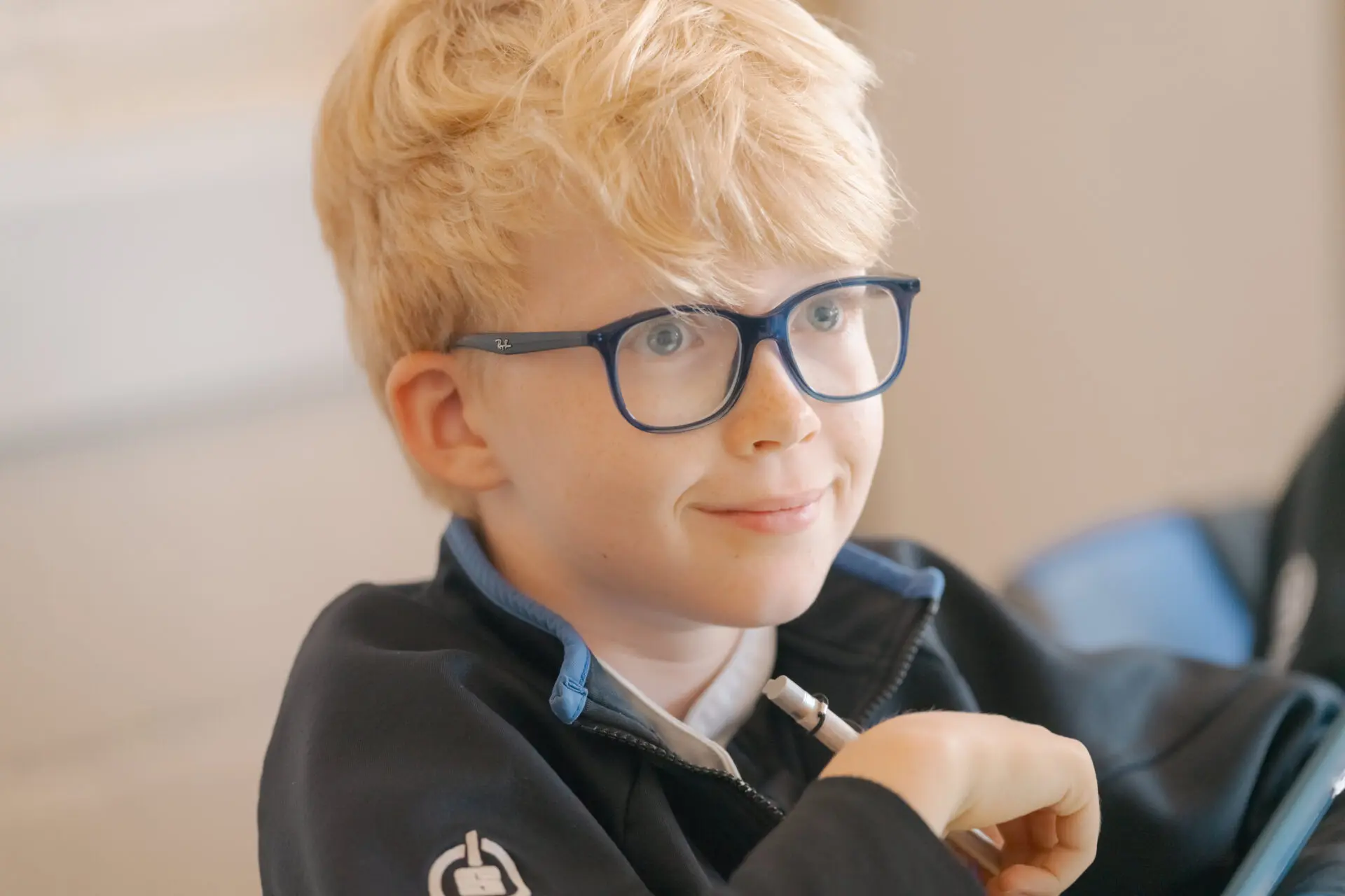 Image of a pupil smiling in class