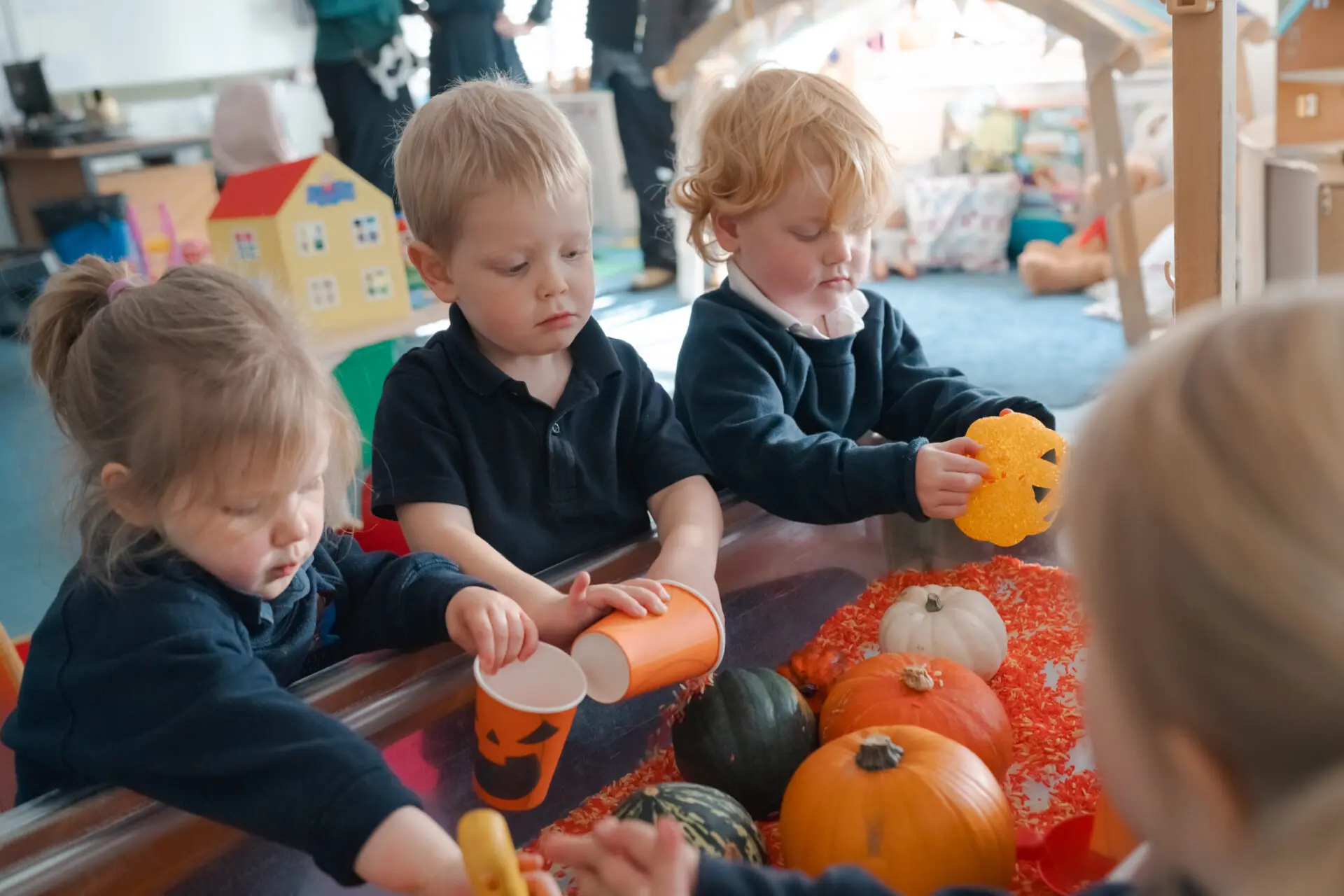 Image of Little Amesbury pupils playing with cups and pumpkins