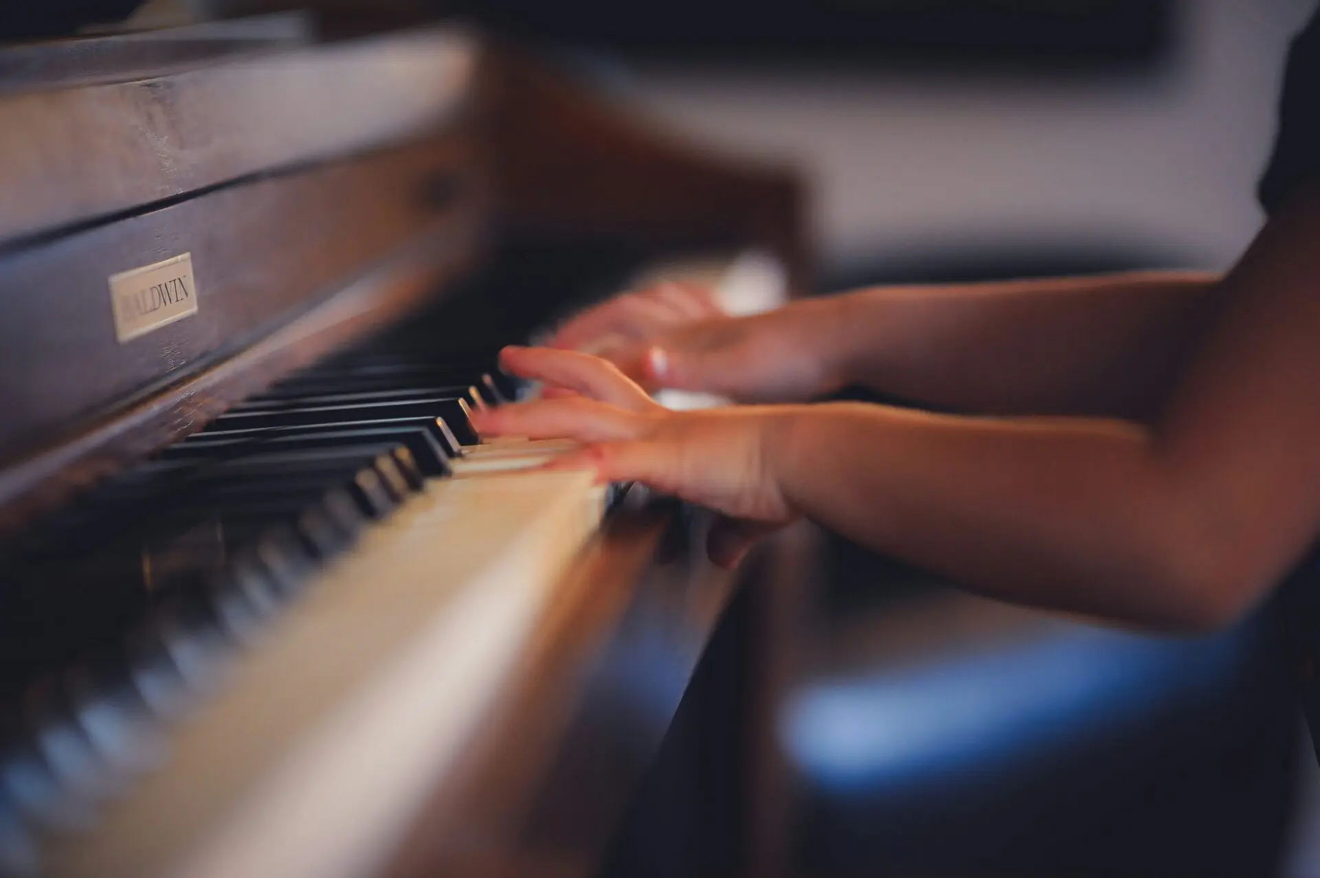 Image of a pupils hands playing piano