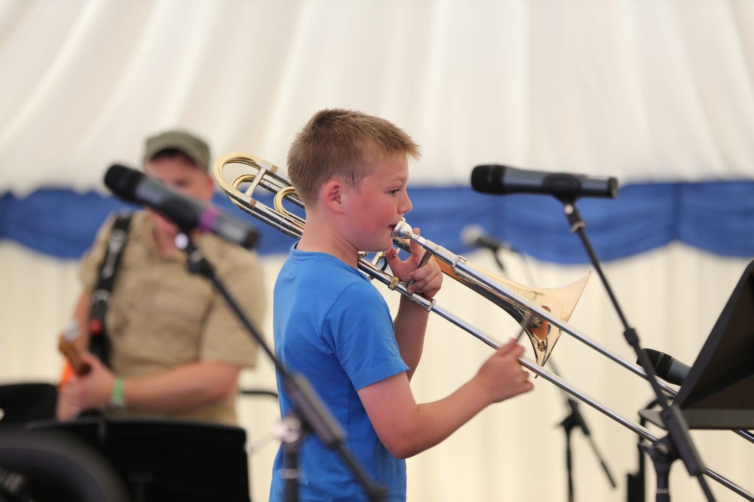 Image of a boy playing a trombone